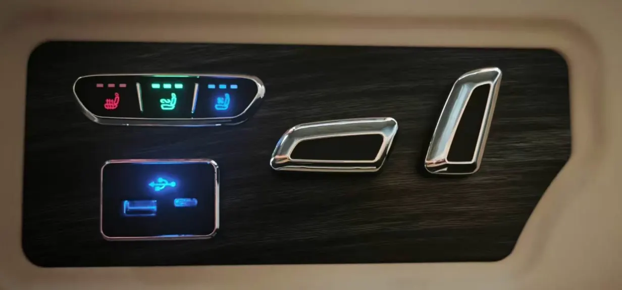Seat control panel in dark wood veneer with seat climate buttons, electric adjustment switches and USB-A and USB-C ports